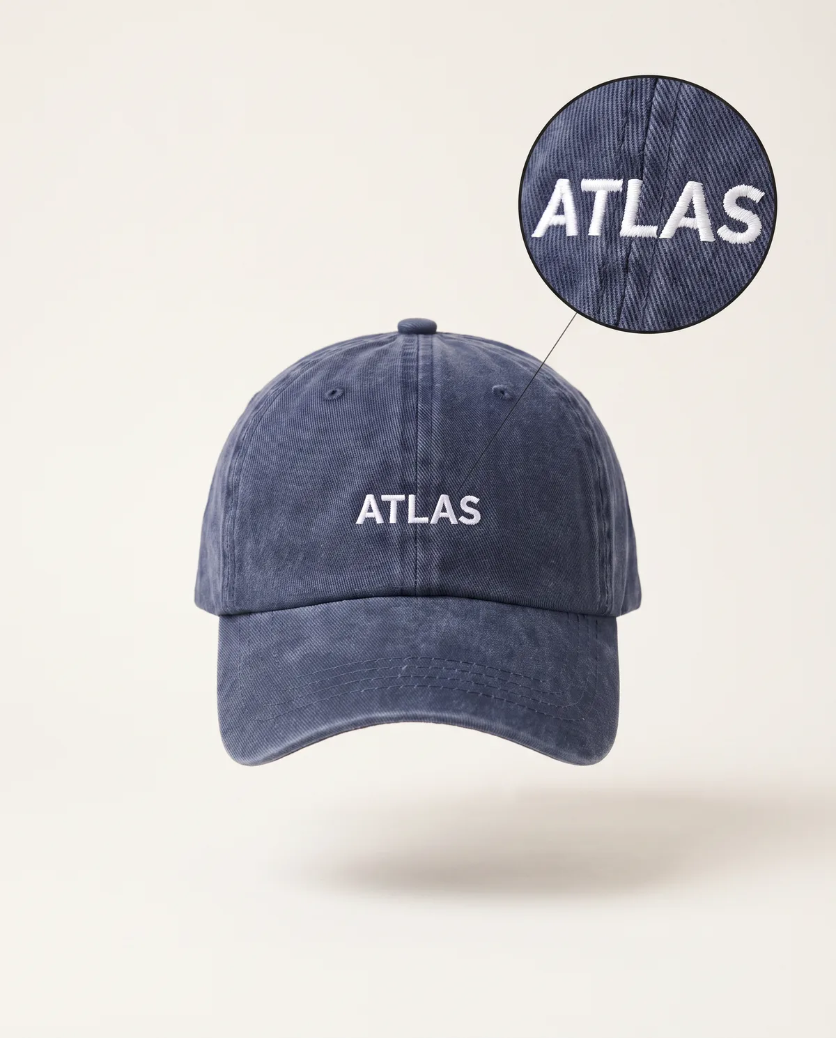 Washed navy cap, white embroidered ATLAS sample mark with zoom loupe