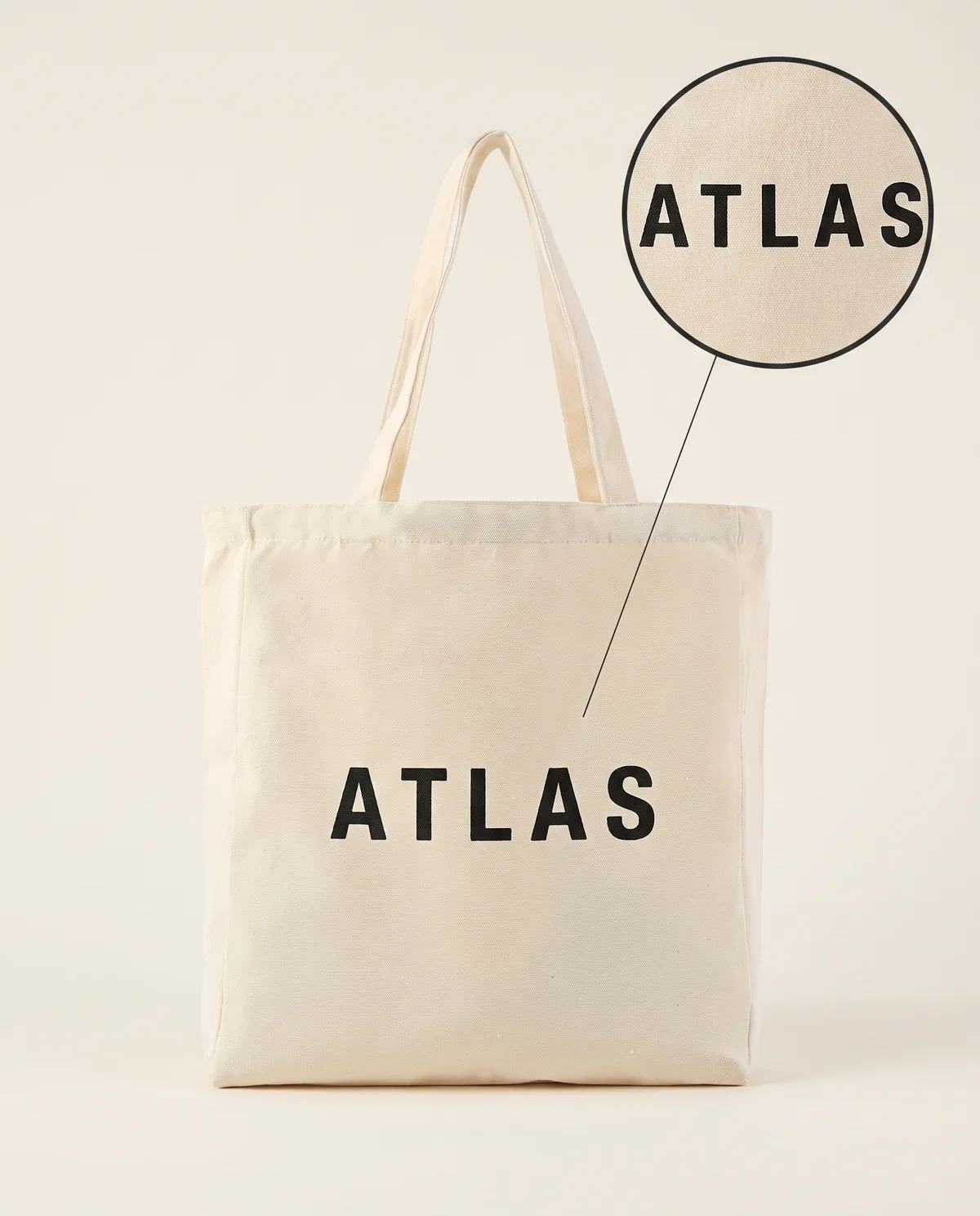 Natural canvas tote, black screen-printed ATLAS sample mark with zoom loupe